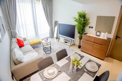 a living room with a couch and a tv at Binghatti Corner in Dubai