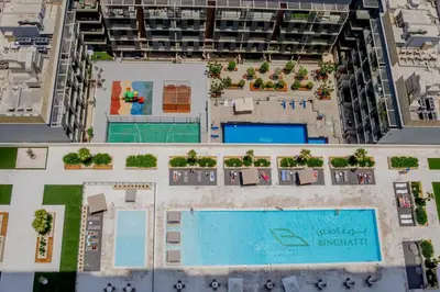 an overhead view of an apartment complex with a swimming pool at Binghatti Corner in Dubai