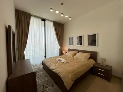 a bedroom with a bed with a phone on it at Binghatti Corner in Dubai
