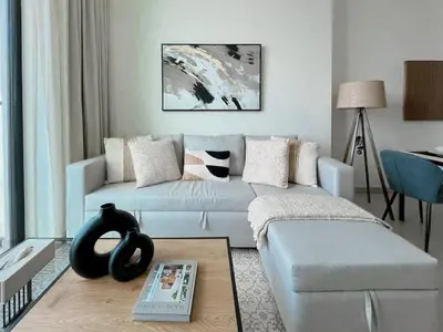 a living room with a couch and a table at Modern 1BR Apt in Binghatti Gardenia with Pool & Gym! in Dubai