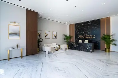 a lobby with white furniture and a large marble floor at Modern 1BR Apt in Binghatti Gardenia with Pool & Gym! in Dubai
