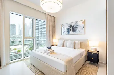 a bedroom with a large bed and a large window at Elegant 2BR, Grand Bleu, Coastal Elegance in Dubai