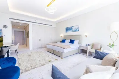 a bedroom with a bed and a living room at Sky-High Elegant Suite at Palm Tower in Dubai