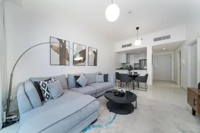 a living room with a couch and a table at High-Floor Elegance | 1-Bedroom with Marina Views in Dubai