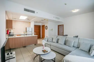 a living room with a couch and a table at Stylish 1BHK in Sulafa Tower at Dubai Marina in Dubai