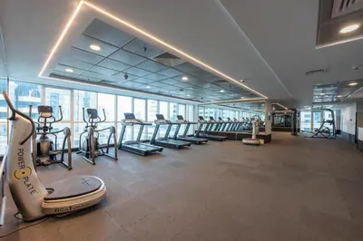 a gym with treadmills and exercise equipment in a building at Stylish 1BHK in Sulafa Tower at Dubai Marina in Dubai