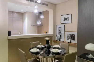 a dining room with a black table and chairs at Luxury 1BHK in Damac Paramount Towers, Business Bay in Dubai