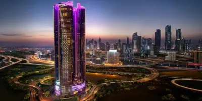 a tall building with purple lights on it in a city at Luxury 1BHK in Damac Paramount Towers, Business Bay in Dubai
