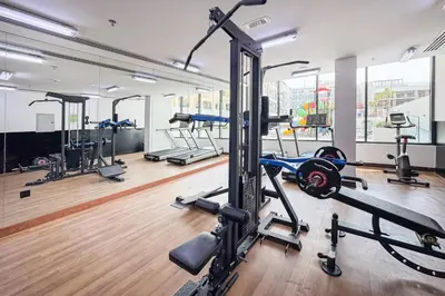 a gym with several treadmills and machines in it at Stylish Studio in JVC Bright, Cozy and Convenient in Dubai