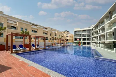 an image of a swimming pool at a hotel at Stylish Studio in JVC Bright, Cozy and Convenient in Dubai