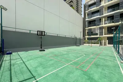 a court with a basketball hoop in a building at Modern JVC 1-Bed Pool, Gym and Family Amenities in Dubai