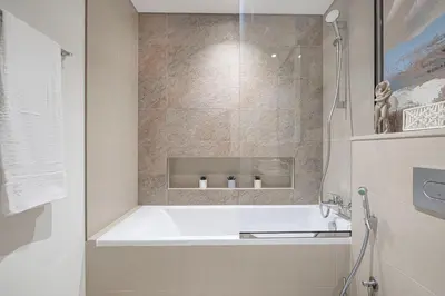 a bathroom with a bath tub and a shower at Boho Comfort - 1BR with Gym, Pool, Tennis, Yoga and Dubai Mall access in Dubai
