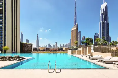 a swimming pool with a view of the city at Boho Comfort - 1BR with Gym, Pool, Tennis, Yoga and Dubai Mall access in Dubai