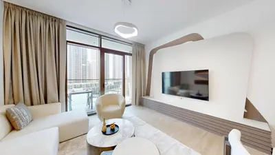 a living room with white furniture and a large window at Vacationer Chic 1 Bedroom Creek Harbour in Dubai