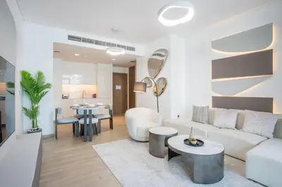 a living room with a couch and a table at Vacationer Chic 1 Bedroom Creek Harbour in Dubai