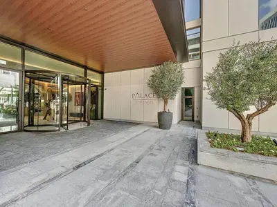 a building with two trees in front of it at Vacationer Chic 1 Bedroom Creek Harbour in Dubai