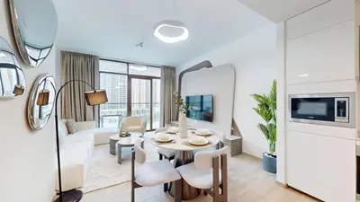 a living room with a table and a couch at Vacationer Chic 1 Bedroom Creek Harbour in Dubai