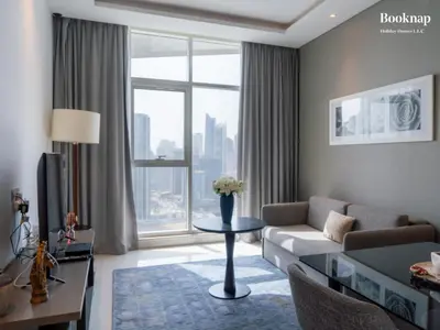 a living room with a couch and a table at Luxury 1BHK Apartment at DAMAC Prive A, Business Bay in Dubai