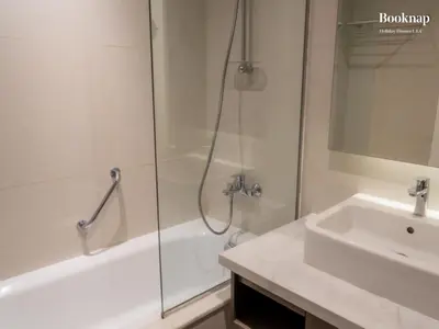 a bathroom with a shower and a sink and a tub at Luxury 1BHK Apartment at DAMAC Prive A, Business Bay in Dubai