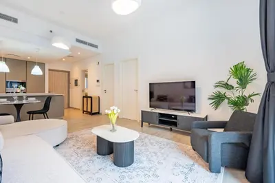 a living room with a couch and a tv at Contemporary 1Bedroom Escape in Eaton Place in Dubai