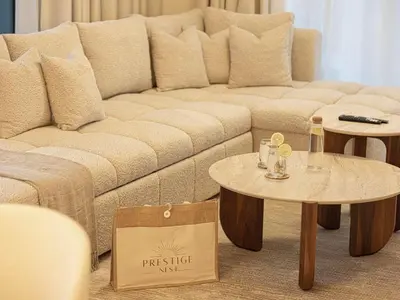 a living room with a couch and two tables at Forte Suites by Prestige Nest in Dubai