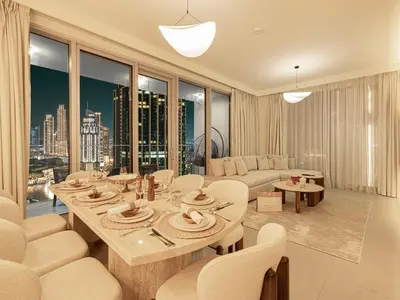 a living room with a table and chairs and a couch at Forte Suites by Prestige Nest in Dubai