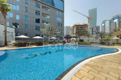 a swimming pool in the middle of a building at Elegant Studio apartment in Avanti Tower Business Bay in Dubai