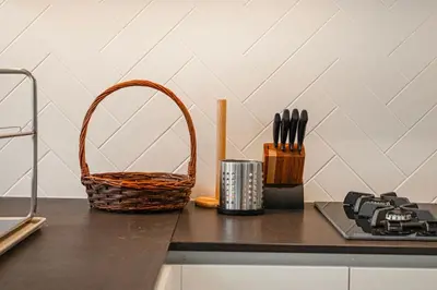 a counter with a basket on a table with a cutting board at Cozy 2-BR at Belgravia Square in Dubai