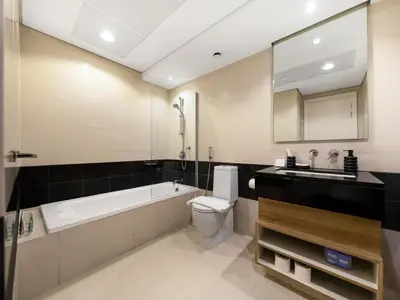 a bathroom with a tub and a toilet and a sink at Luxury Stay in Downtown-Steps to Burj & Dubai Mall in Dubai