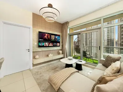 a living room with a couch and a tv at Luxury Stay in Downtown-Steps to Burj & Dubai Mall in Dubai