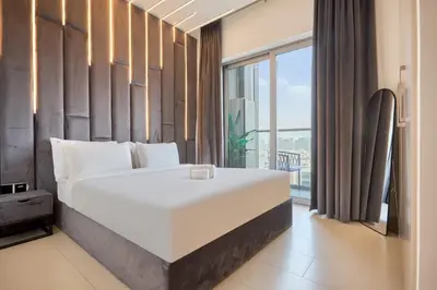 a bedroom with a large bed and a large window at STAY BY LATINEM Luxury 1BR Holiday Home CVR A511 near Downtown in Dubai