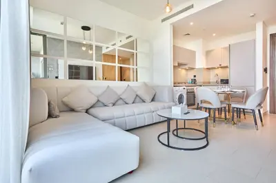 a living room with a white couch and a table at STAY BY LATINEM Luxury 1BR Holiday Home CVR A511 near Downtown in Dubai
