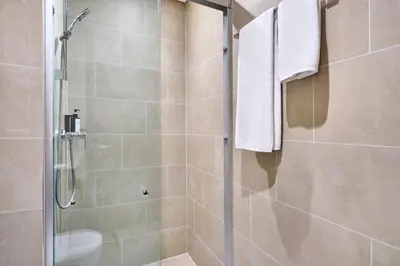 a shower stall with a glass door in a bathroom at STAY BY LATINEM Luxury 1BR Holiday Home CVR B 602 near Downtown in Dubai