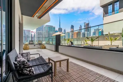 a balcony with a couch and a table and a view of the city at Burj Khalifa View 2BR at Binghatti Canal in Dubai