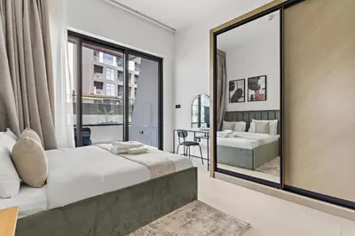 a bedroom with a bed and a mirror at Burj Khalifa View 2BR at Binghatti Canal in Dubai