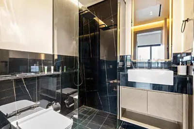 a bathroom with a sink and a toilet and a shower at Burj Khalifa View 2BR at Binghatti Canal in Dubai