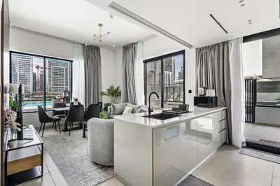 a living room with a couch and a table at Burj Khalifa View 2BR at Binghatti Canal in Dubai