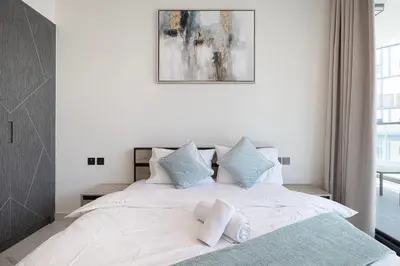 a bedroom with a large bed with two pillows at Park Views by Samana with Private Pool in Dubai
