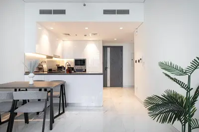 a kitchen and dining room with a table and chairs at Park Views by Samana with Private Pool in Dubai