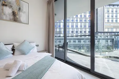 a bedroom with a bed and a large window at Park Views by Samana with Private Pool in Dubai