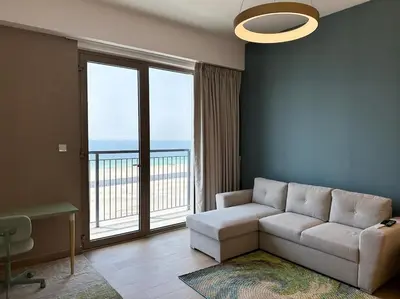a living room with a couch and a large window at NYE Firework View - Beachfront Residence - Sea View in Dubai