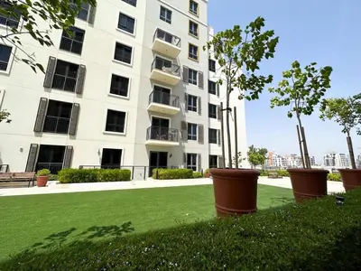 a large apartment building with a lawn in front of it at NYE Firework View - Beachfront Residence - Sea View in Dubai
