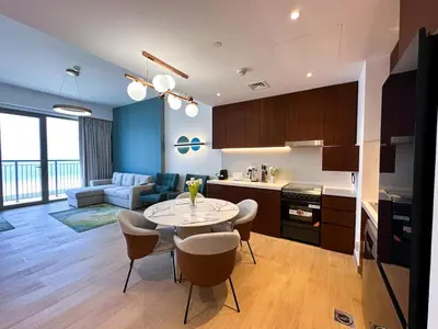 a kitchen and living room with a table and chairs at NYE Firework View - Beachfront Residence - Sea View in Dubai