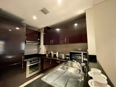 a kitchen with a sink and a microwave at Specious 1 Br In Royal Amwaj Residences South in Dubai