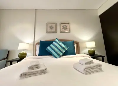 a bedroom with a bed with towels on it at Specious 1 Br In Royal Amwaj Residences South in Dubai
