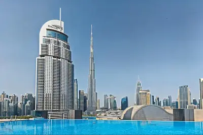 a view of a city skyline with a swimming pool at Vogue Downtown Boulevard Point near Burj Khalifa and Dubai Mall, One Bedroom Apartment with Burj Khalifa view from the Balcony and Access to all Amenities in Dubai