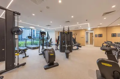 a gym with treadmills and cardio equipment in a building at Creek Harbour Serenity with Burj Khalifa Glimpse in Dubai