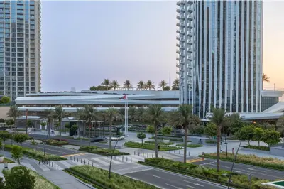a view of a building with palm trees and buildings at Creek Harbour Serenity with Burj Khalifa Glimpse in Dubai