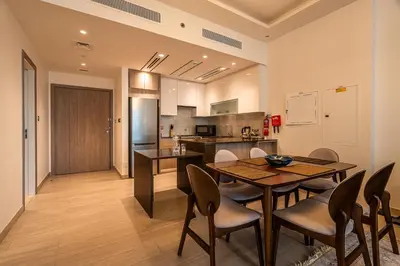 a kitchen and dining room with a table and chairs at Spacious 2 Bedrooms with maid room I JLT in Dubai