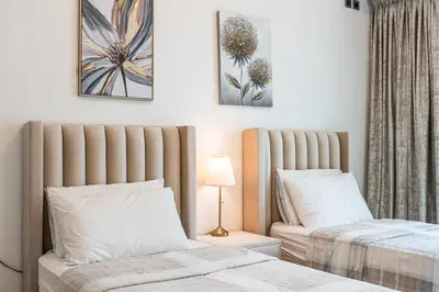 two beds sitting next to each other in a bedroom at Spacious 2 Bedrooms with maid room I JLT in Dubai